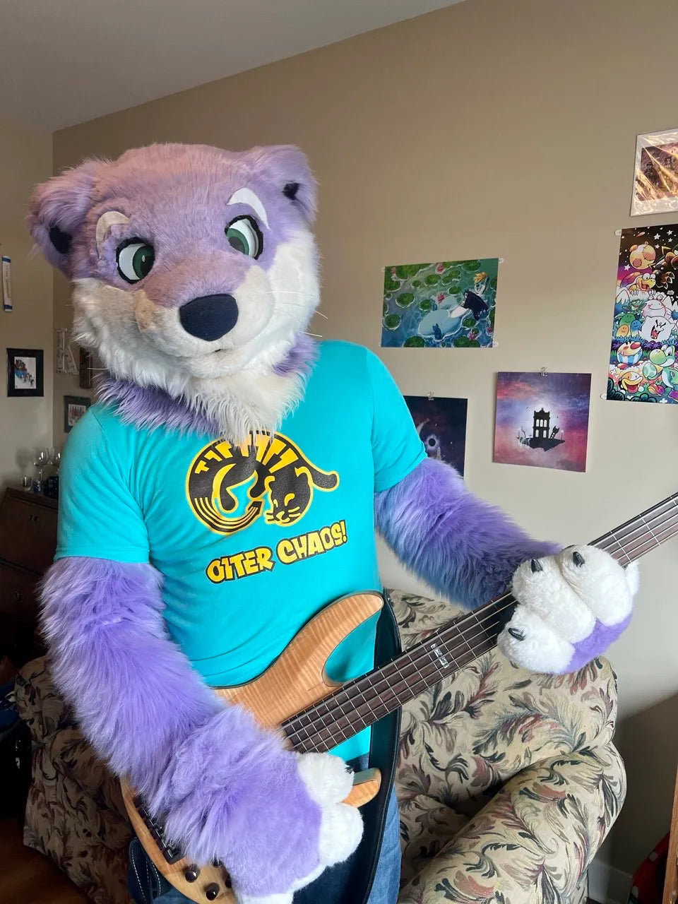 Cornel the Otter weraing the Otter Chaos! shirt and playing bass!